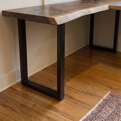 Side view of solid wood L-shaped corner desk with matte black steel legs