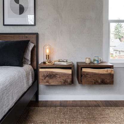 Pair of solid wood floating nightstands with live edge drawers mounted beside a bed