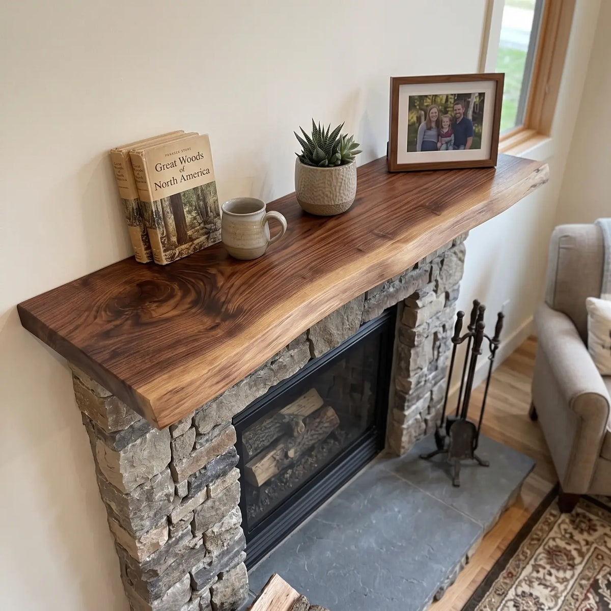 Solid wood live edge fireplace mantel shelf above a stone fireplace, styled with books, a mug, plant and framed photo