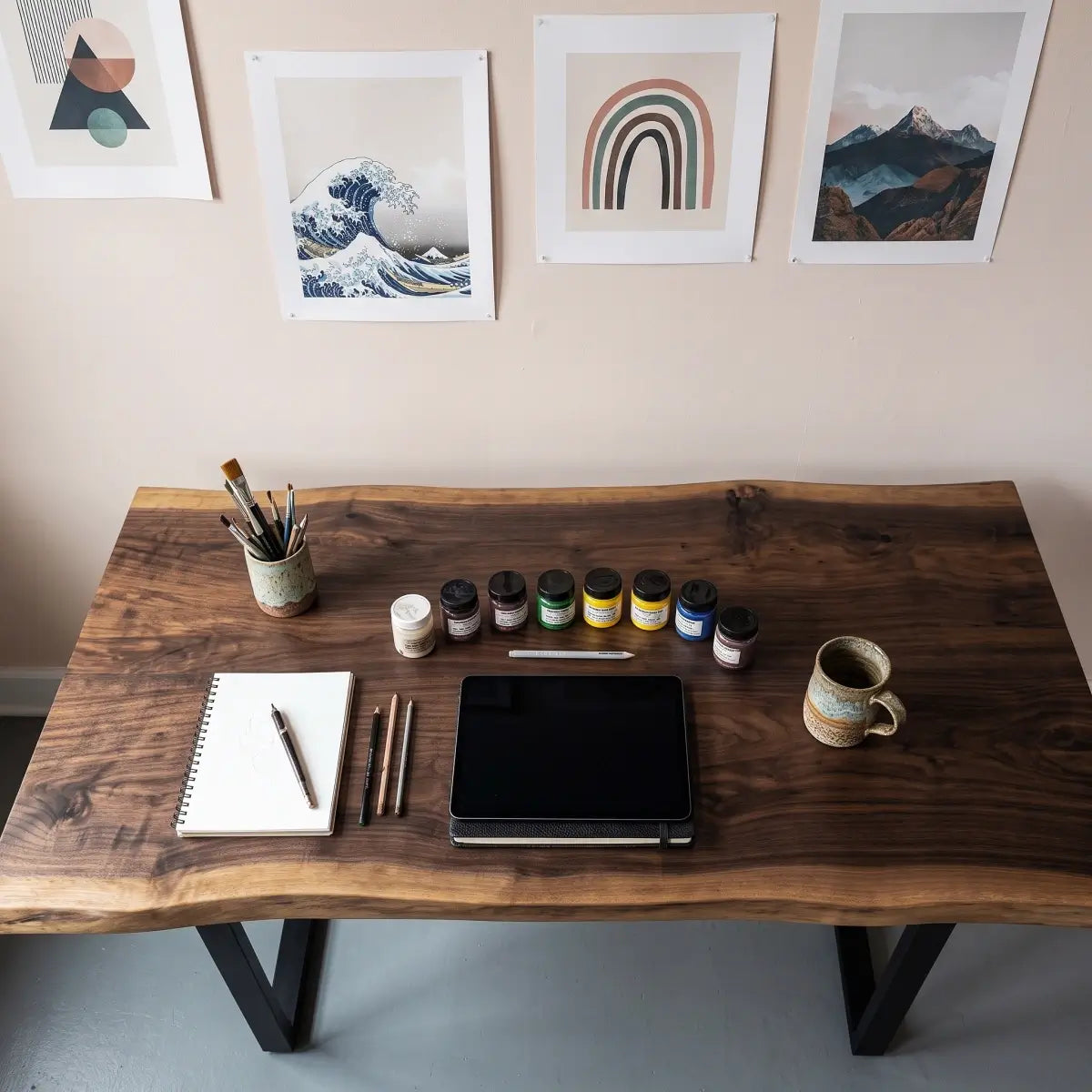 Top view of live edge computer desk with monitor, keyboard and office accessories