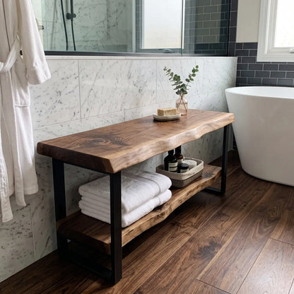 Solid wood live edge bathroom bench beside a bathtub with towels on the lower shelf